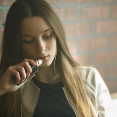 young woman vaping 